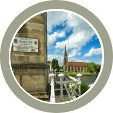 close up of Marlow bridge sign with church in background