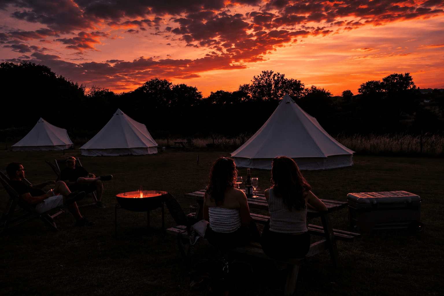 People around a lit firepit at dusk