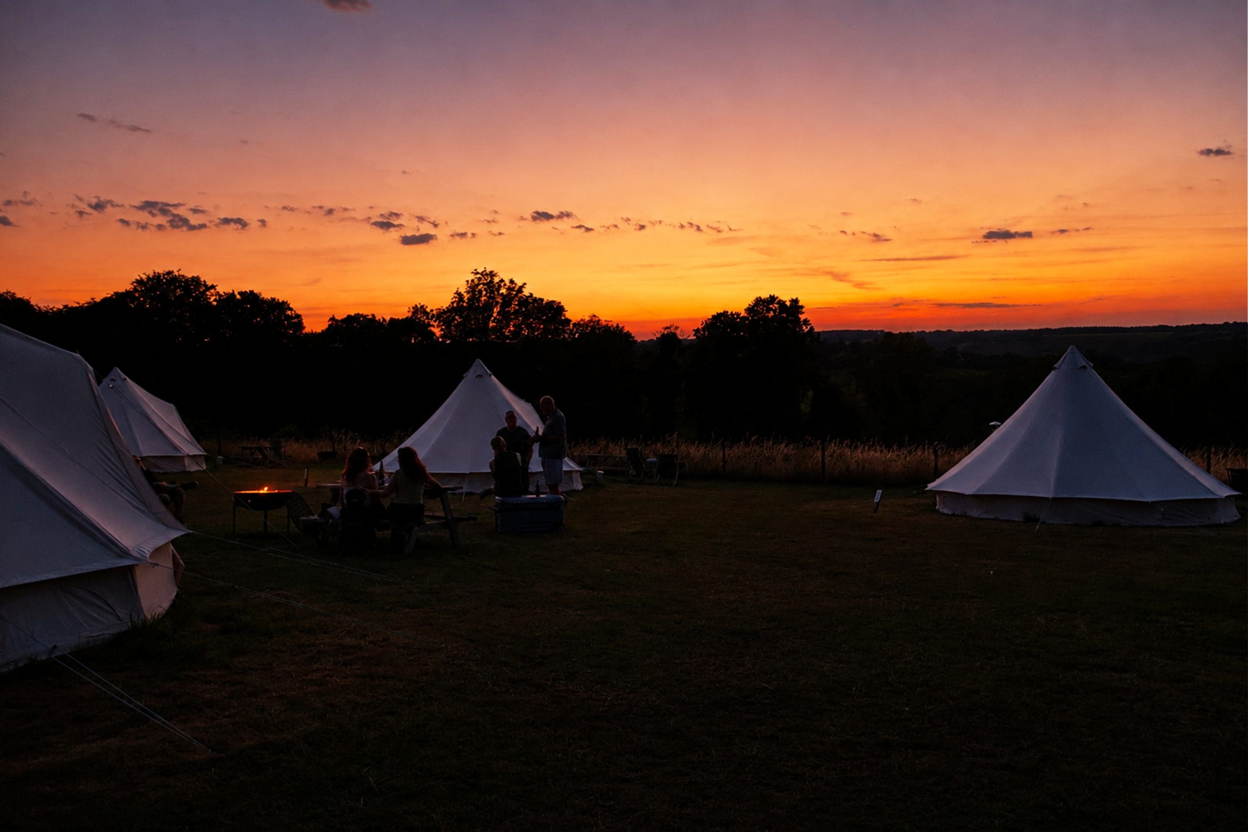 Sunset with people talking around a fire pit